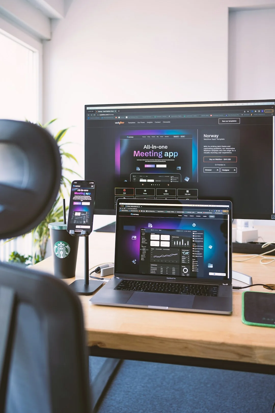 A contemporary workspace showcasing a laptop, tablet, and smartphones, ideal for tech and freelance use.